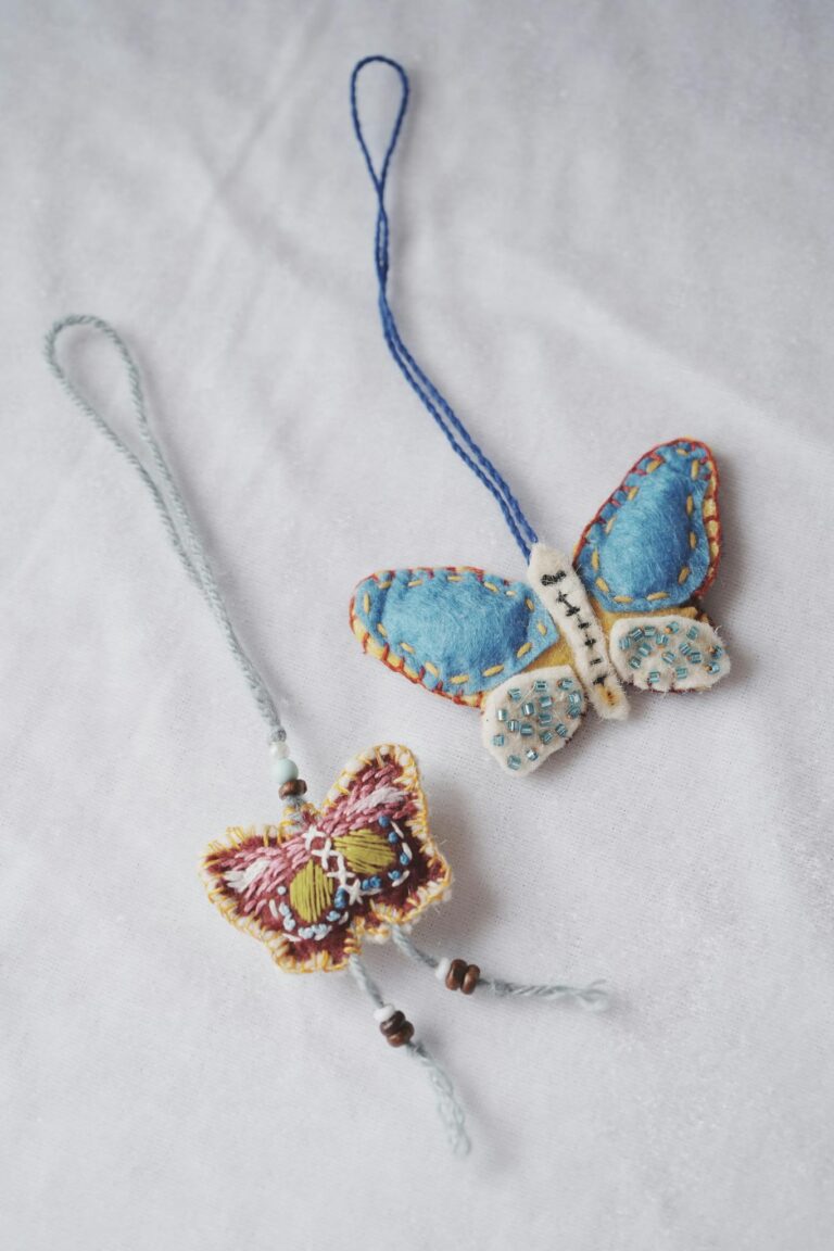 Vibrant handmade butterfly ornaments with intricate stitching and beading.